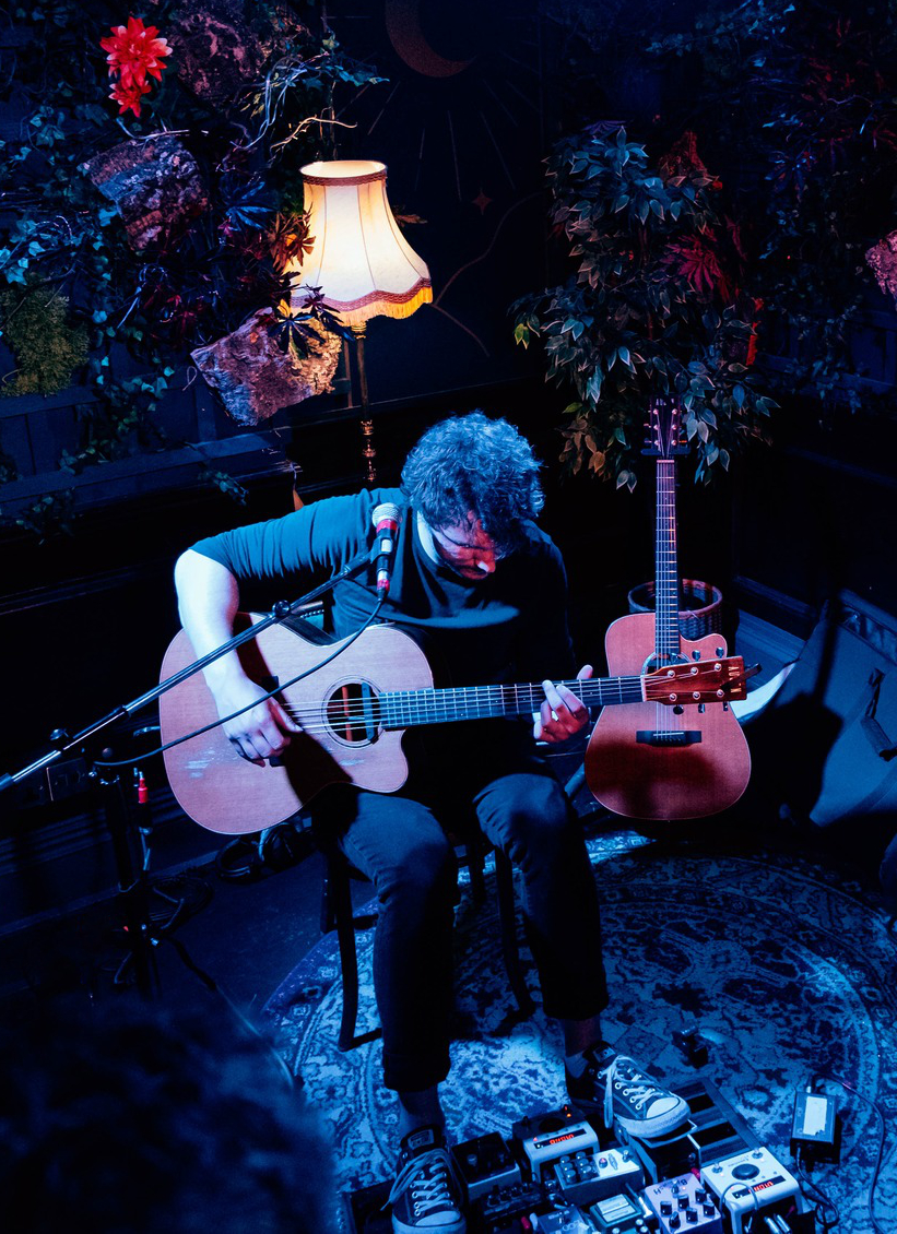 Scott Booth performing live with guitar and pedalboard